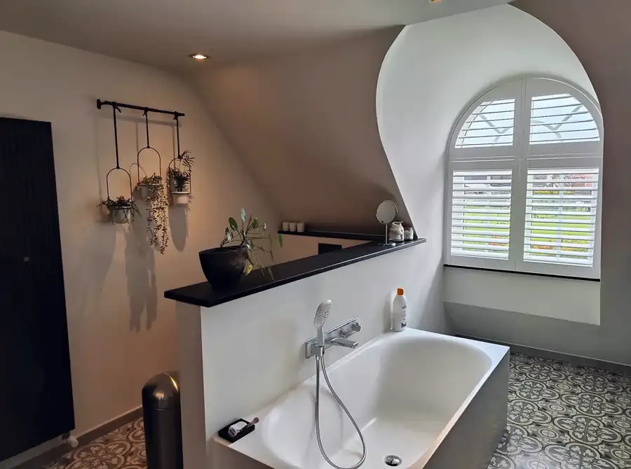 Kunststoff-Shutters für ein Bogenfenster im Badezimmer in Arendonk